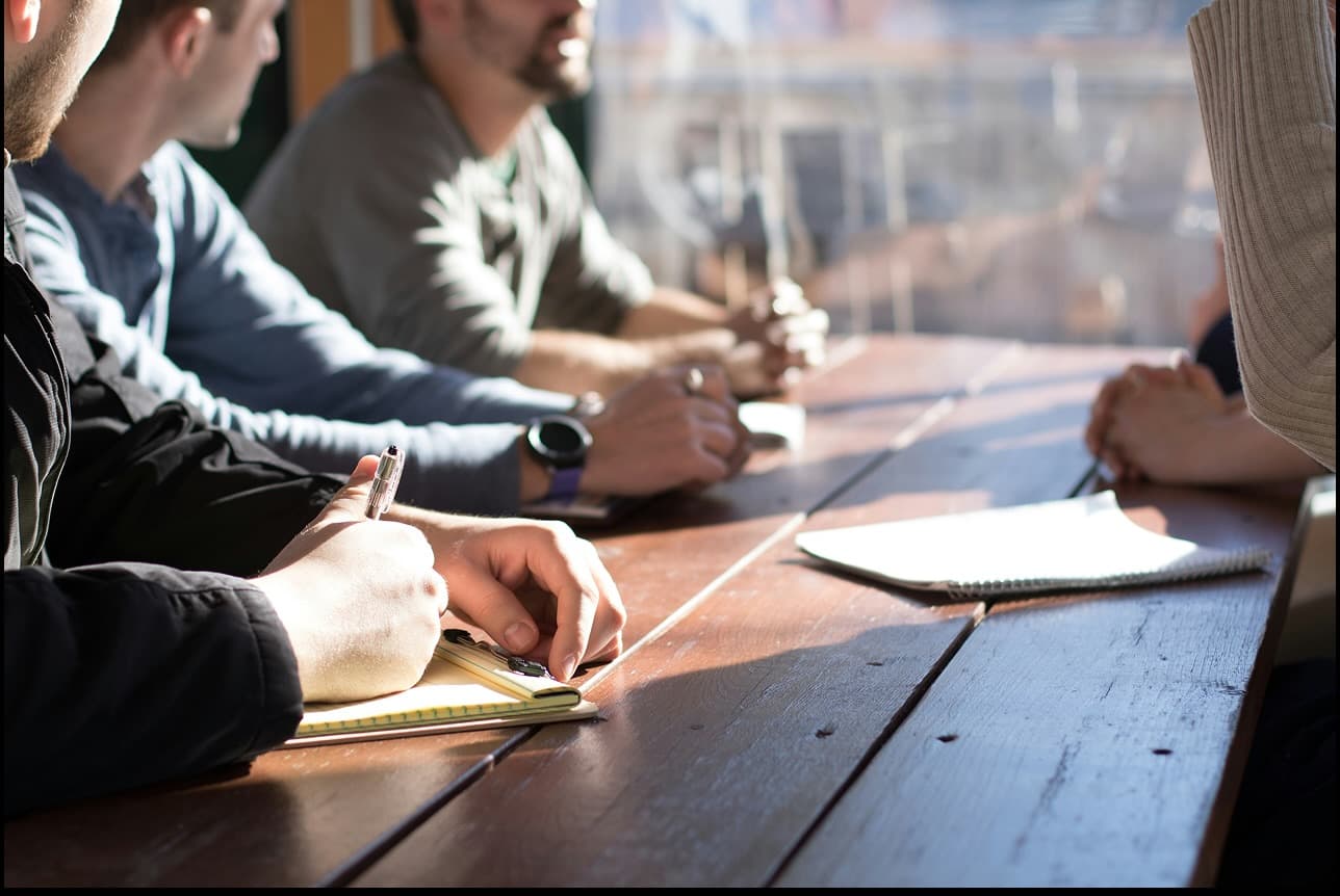 Cooperative members reviewing investment records